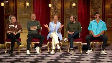 Image of the panel of contestants seated on stage together during this episode.