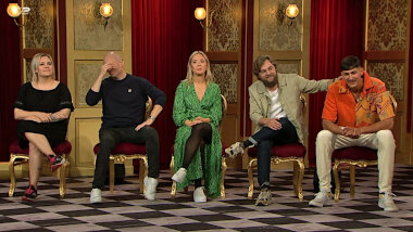 Image of the panel of contestants seated on stage together during this episode.