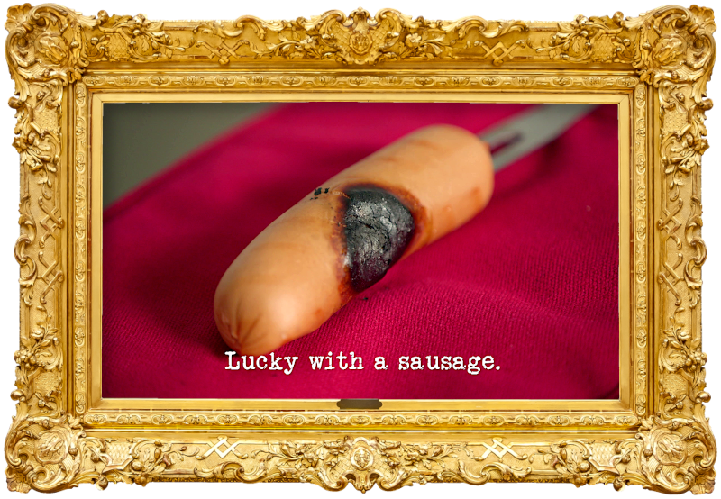 Image of a burned sausage on the end of a fork (a reference to the 'Save the snag from the barbie' task), with the episode title, 'Lucky with a sausage', superimposed on it. Image of a burned sausage on the end of a fork (a reference to the 'Save the snag from the barbie' task), with the episode title, 'Lucky with a sausage', superimposed on it.
