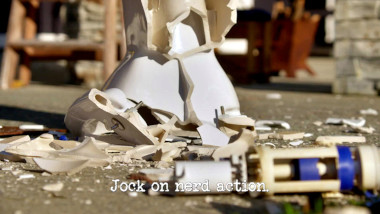 Image of a shattered porcelain toilet on a concrete floor (a reference to Tommy Little's attempt at the 'Be a man' task), with the episode title 'Jock on nerd action' superimposed on it.