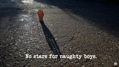 Image of a mannequin's hand stood on a tarmac surface, and backlit by a low sun, casting a long shadow (a reference to the 'Invent a new handshake' task), with the episode title, 'No stars for naughty boys', superimposed on it.