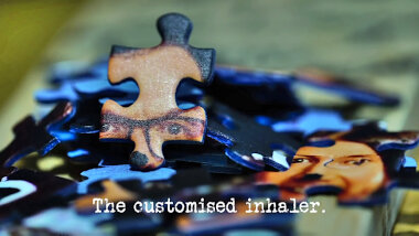 Image of the pieces of an unsolved jigsaw puzzle (a reference to the 'Solve the riddle' task), with the episode title, 'The customised inhaler', superimposed on it.