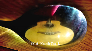 Photo of an guitar reflected in the convex side of a spoon (a reference to the 'Musical Simon Says' and 'Salvage the most spoons' tasks), with the episode title, 'Old Honkfoot', superimposed on it.