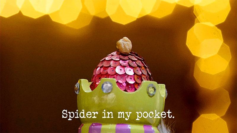 Photo of a colourful ceramic crown with a sequin-covered egg inside it, and a chickpea balanced on top (a reference to the 'Be the best waiter' and 'Get a hat onto the Taskmaster’s head' tasks), with the episode title, 'Spider in my pocket', superimposed on it. Photo of a colourful ceramic crown with a sequin-covered egg inside it, and a chickpea balanced on top (a reference to the 'Be the best waiter' and 'Get a hat onto the Taskmaster’s head' tasks), with the episode title, 'Spider in my pocket', superimposed on it.