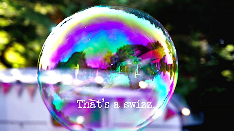 Close-up image of a soap bubble (presumably a reference to footage of the contestants shown during the title sequence), with the episode title, 'That's a swizz', superimposed on it. Close-up image of a soap bubble (presumably a reference to footage of the contestants shown during the title sequence), with the episode title, 'That's a swizz', superimposed on it.