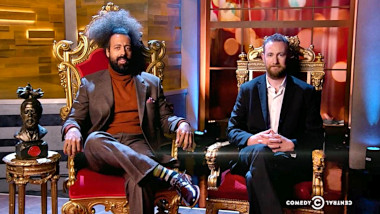 Cover image for the US show Taskmaster US, showing the hosts of the show, Reggie Watts and Alex Horne.
