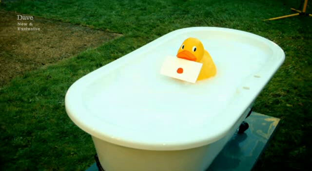 Sealed task held in the beak of a large rubber duck which is floating in a clawfoot bathtub in the yard. Sealed task held in the beak of a large rubber duck which is floating in a clawfoot bathtub in the yard.