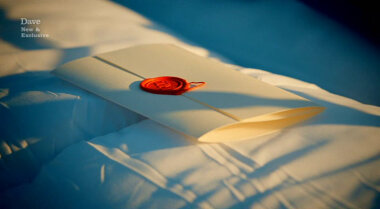 Image showing the task brief lying on top of some pillows on an unmade bed.