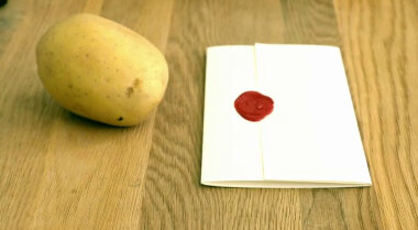 Sealed task brief and a potato on the living room table.