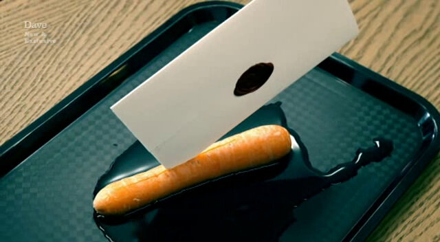 Sealed task brief poking out of a carrot sitting in a puddle of water on a lunch tray.
