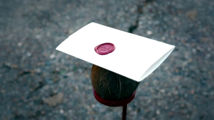 Sealed task brief resting on a coconut placed in a stand in the driveway. Sealed task brief resting on a coconut placed in a stand in the driveway.