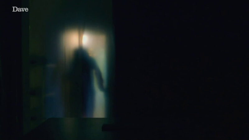 A dark ghostly figure appearing blurry in a doorway. A dark ghostly figure appearing blurry in a doorway.