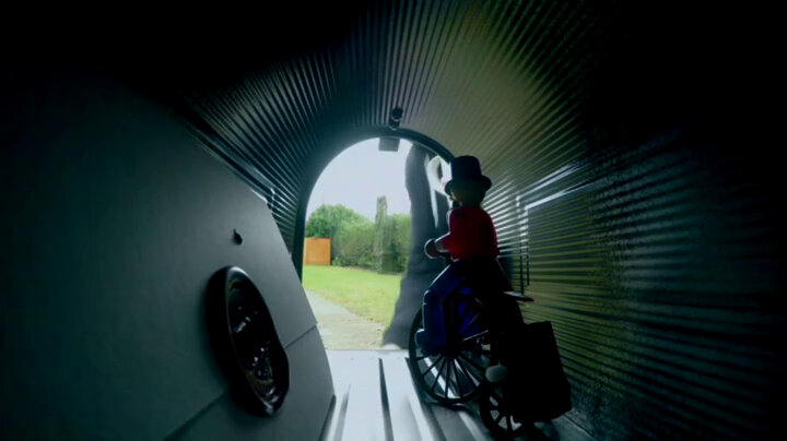 A sealed task brief inside the caravan mailbox. A wind-up man on a bicycle sits next to the task. A sealed task brief inside the caravan mailbox. A wind-up man on a bicycle sits next to the task.