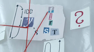 Cryptic notes on paper taped to plastic sheeting with red string running between the paper notes.