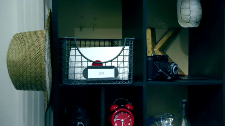 A sealed task brief in a wire basket which is labelled 'Liza'. A sealed task brief in a wire basket which is labelled 'Liza'.