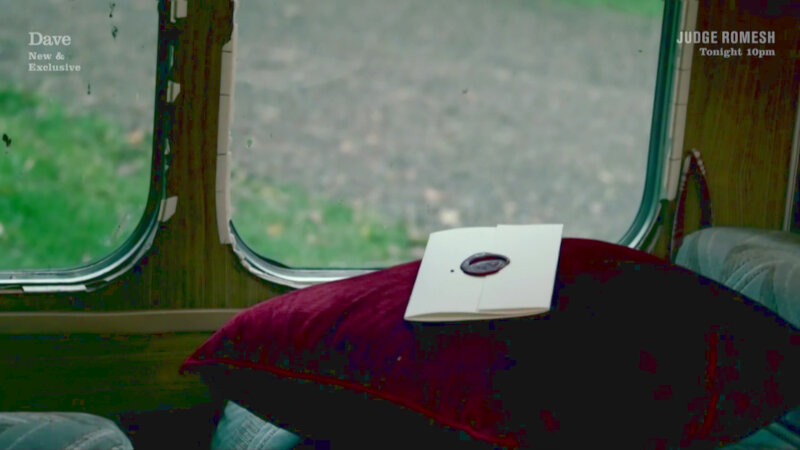 A sealed task on top of a red pillow inside the caravan. A sealed task on top of a red pillow inside the caravan.