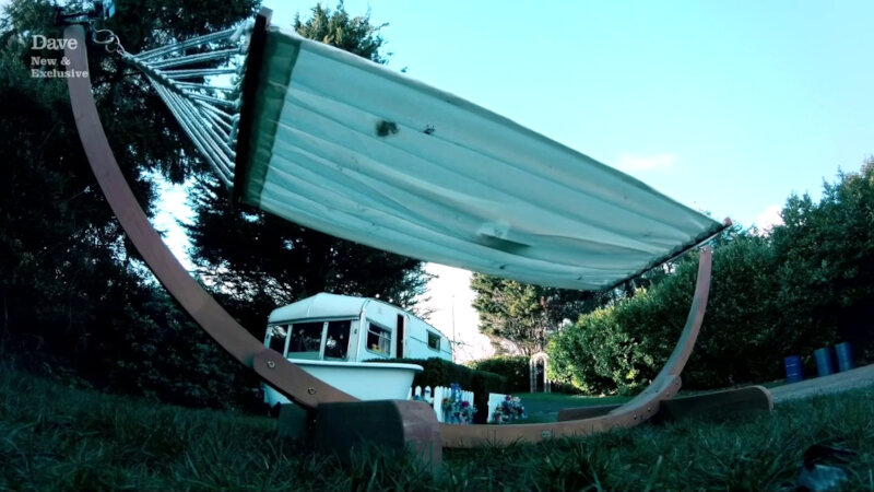 A freestanding hammock on the lawn of the Taskmaster house. The caravan can be seen in the background. A freestanding hammock on the lawn of the Taskmaster house. The caravan can be seen in the background.