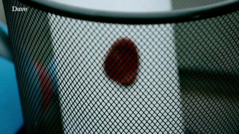 A close-up of a black wire trash bin. In the bin is a sealed task. A close-up of a black wire trash bin. In the bin is a sealed task.
