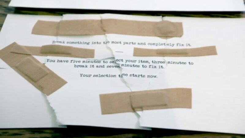 An unsealed task that has been torn up and repaired with bandages. The task reads 'Break something into the most parts and completely fix it. You have five minutes to select your item, three minutes to break it and seven minutes to fix it. Your selection time starts now.' An unsealed task that has been torn up and repaired with bandages. The task reads 'Break something into the most parts and completely fix it. You have five minutes to select your item, three minutes to break it and seven minutes to fix it. Your selection time starts now.'