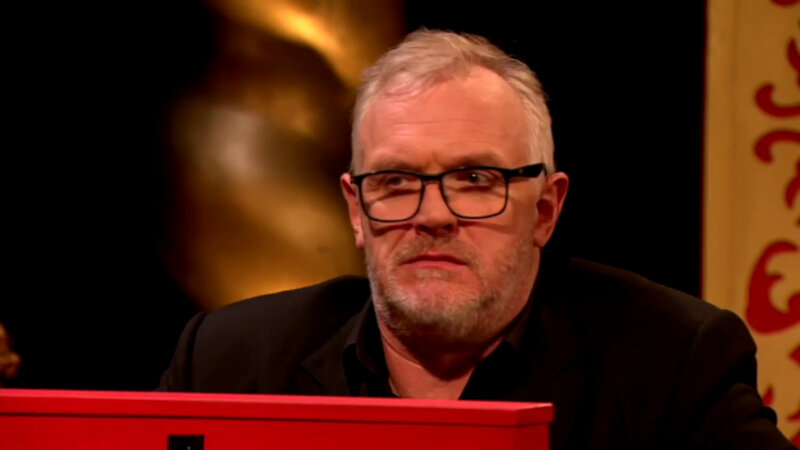Greg Davies in the Taskmaster studio. He is looking over a small red partition. Greg Davies in the Taskmaster studio. He is looking over a small red partition.