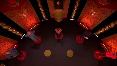An overhead shot of the Taskmaster studio stage. On the stage are the Taskmaster contestants, each standing on a round Taskmaster logo. In front of them are two golden circles.