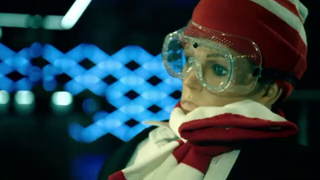 A close-up of a mannequin. It is wearing a red and white striped scarf and matching knit hat. Also a pair of clear safety goggles and a black jacket. A close-up of a mannequin. It is wearing a red and white striped scarf and matching knit hat. Also a pair of clear safety goggles and a black jacket.