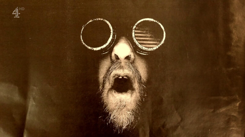 A copy-machine image of Alex Horne wearing dark goggles and roaring. A copy-machine image of Alex Horne wearing dark goggles and roaring.