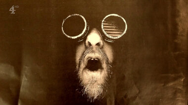 A copy-machine image of Alex Horne wearing dark goggles and roaring.
