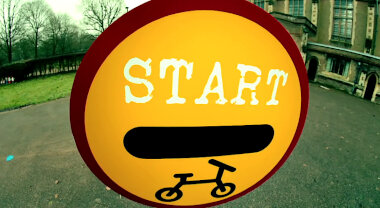 A round road sign reading 'Start'. It has an image of a bicycle.