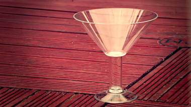 A martini glass standing on the patio.