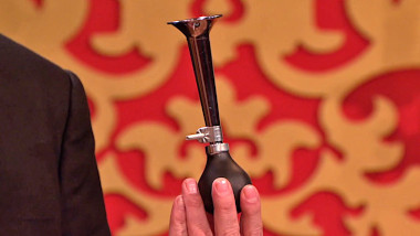 A bicycle horn held gingerly in Greg Davies' fingers.