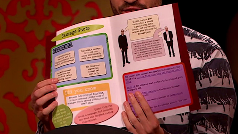 Ivo Graham holding a brochure filled with sausage facts. Ivo Graham holding a brochure filled with sausage facts.