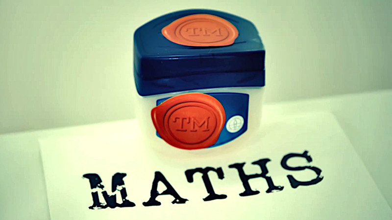 A container of Vaseline sitting on a white card that says 'MATHS'. A container of Vaseline sitting on a white card that says 'MATHS'.