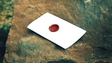 A sealed task brief resting on a rock.