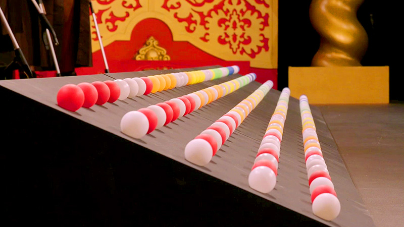 Five rows of ping-pong balls on an incline stretching into the distance. Five rows of ping-pong balls on an incline stretching into the distance.