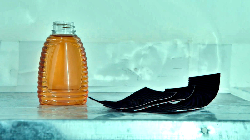 A bottle of honey and some Velcro resting on the lab table. A bottle of honey and some Velcro resting on the lab table.
