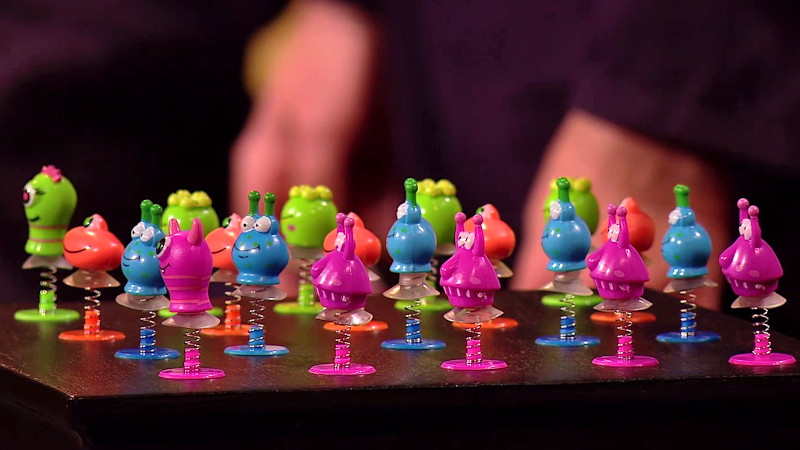 A bunch of cartoonish monster pop-up toys laid out in a grid. They are all brightly coloured in pink, blue, red or green. A bunch of cartoonish monster pop-up toys laid out in a grid. They are all brightly coloured in pink, blue, red or green.