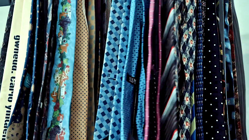 Many ties with many patterns hanging vertically. Many ties with many patterns hanging vertically.