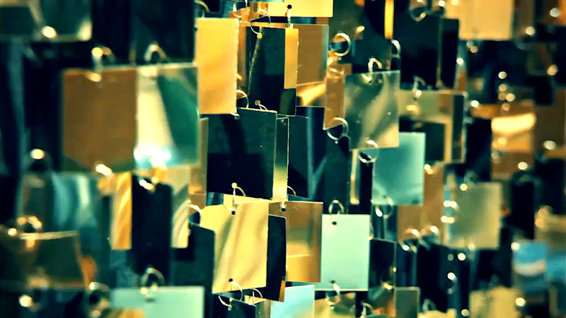 A close-up shot of a gold-mirrored curtain. A close-up shot of a gold-mirrored curtain.